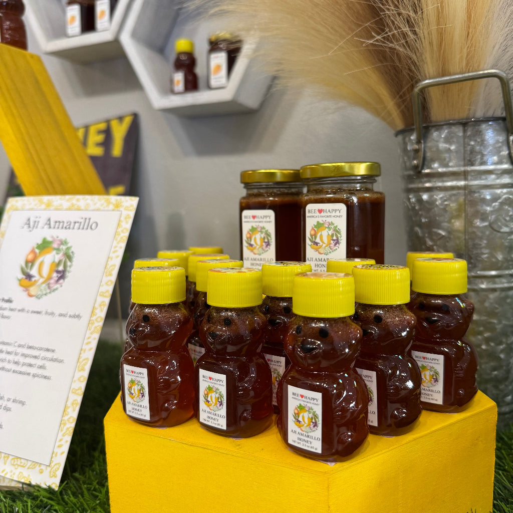 2.3 oz bear bottle of Aji Amarillo Honey on a wooden display