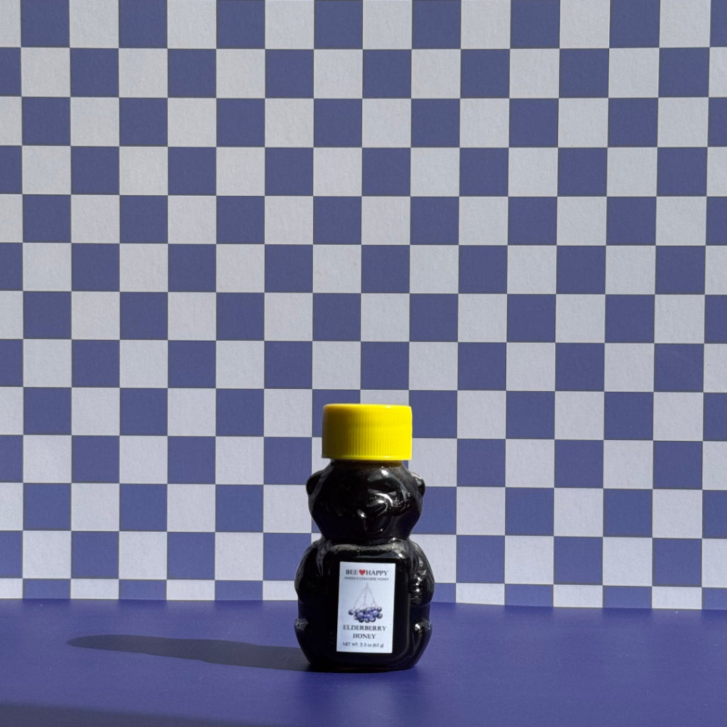 Honey bear container with yellow cap on a blue and white checkered background