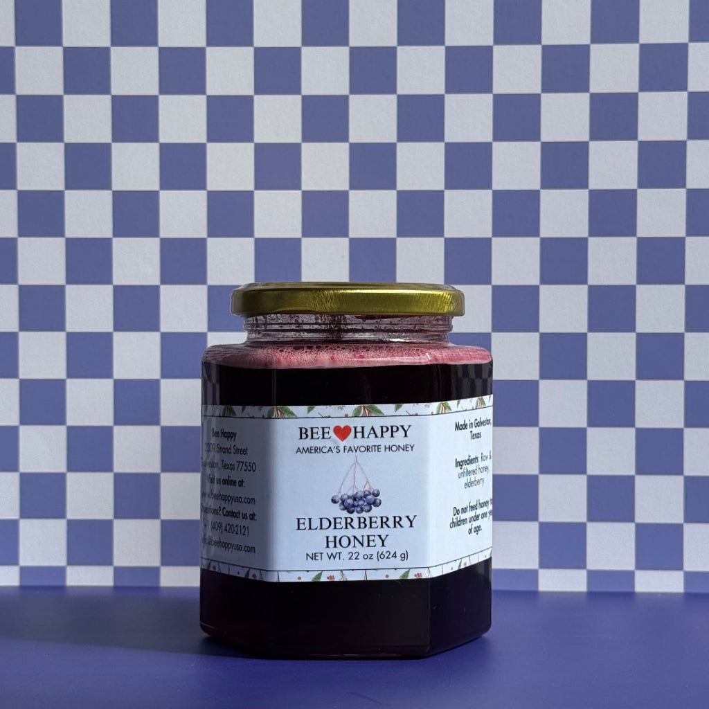 Jar of Bee Happy Elderberry Honey on a blue and white checkered background