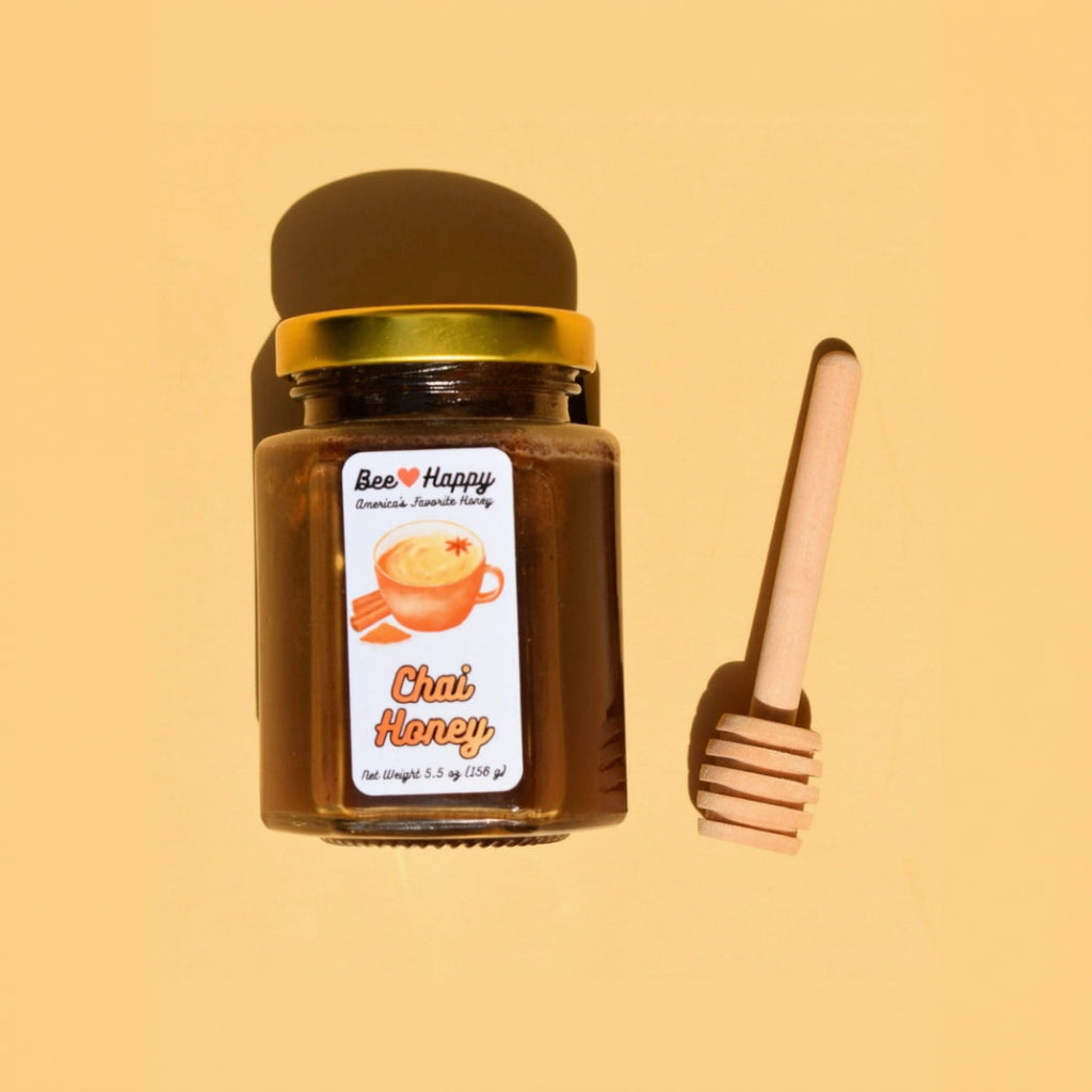 a 5.5 oz jar of Chai Honey and a wooden honey dipper on a beige background