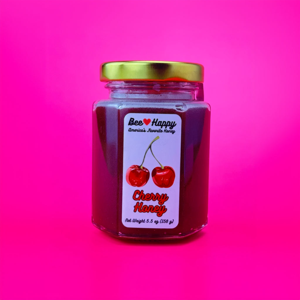 a 5.5 oz jar of Cherry Honey against a pink backbround