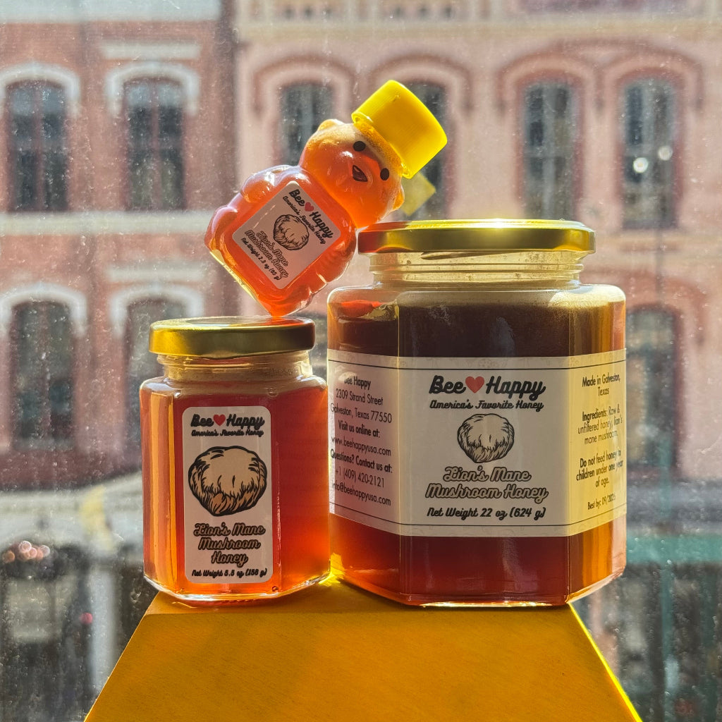 2.3 oz bear bottle, 5.5 oz jar and 22 oz jar of Lion's Mane Mushroom Honey with a window overlooking a building in the back
