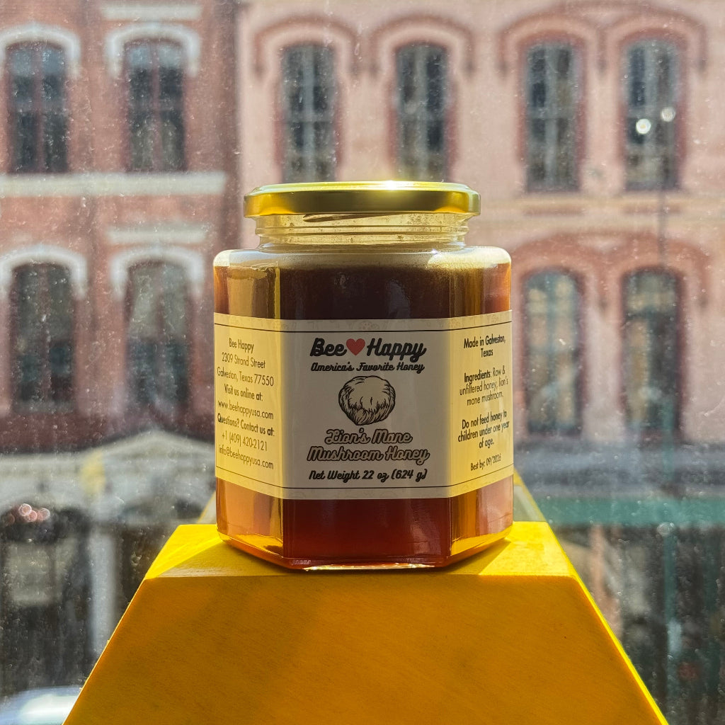 22 oz jar of Lion's Mane Mushroom Honey on a yellow hexagon display with a window overlooking a building in the back