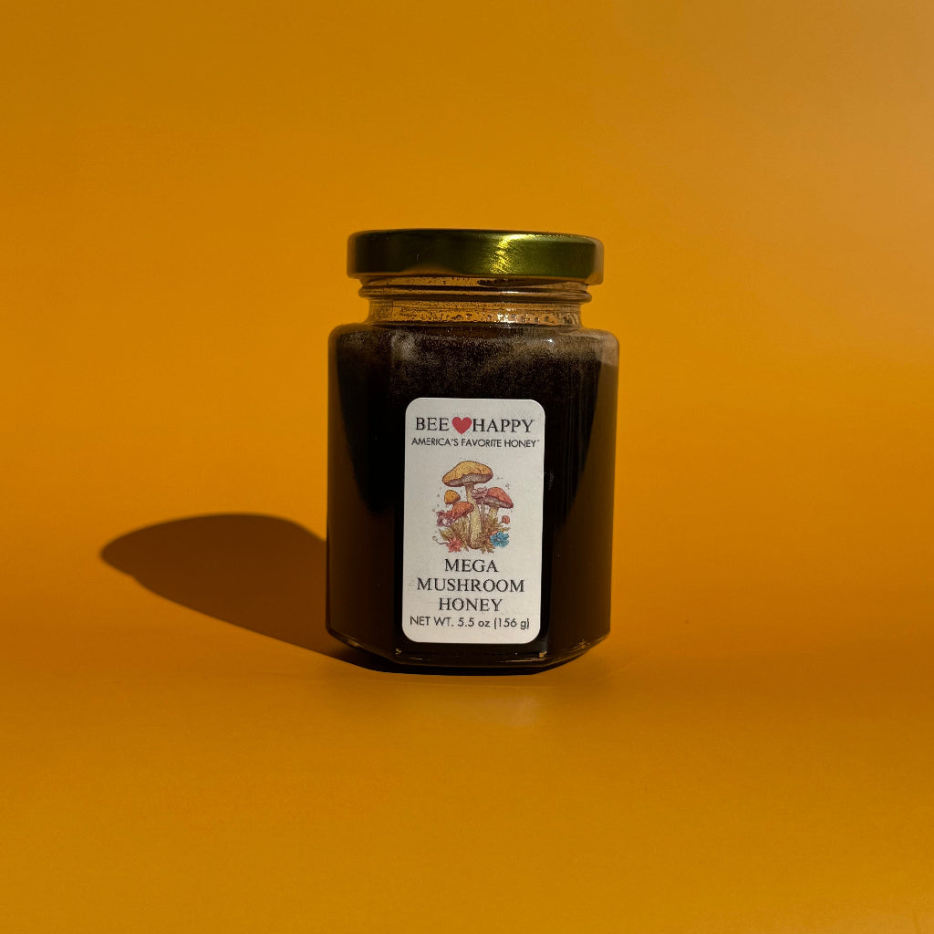 5.5 oz jar of Bee Happy Mega Mushroom Honey on an orange background