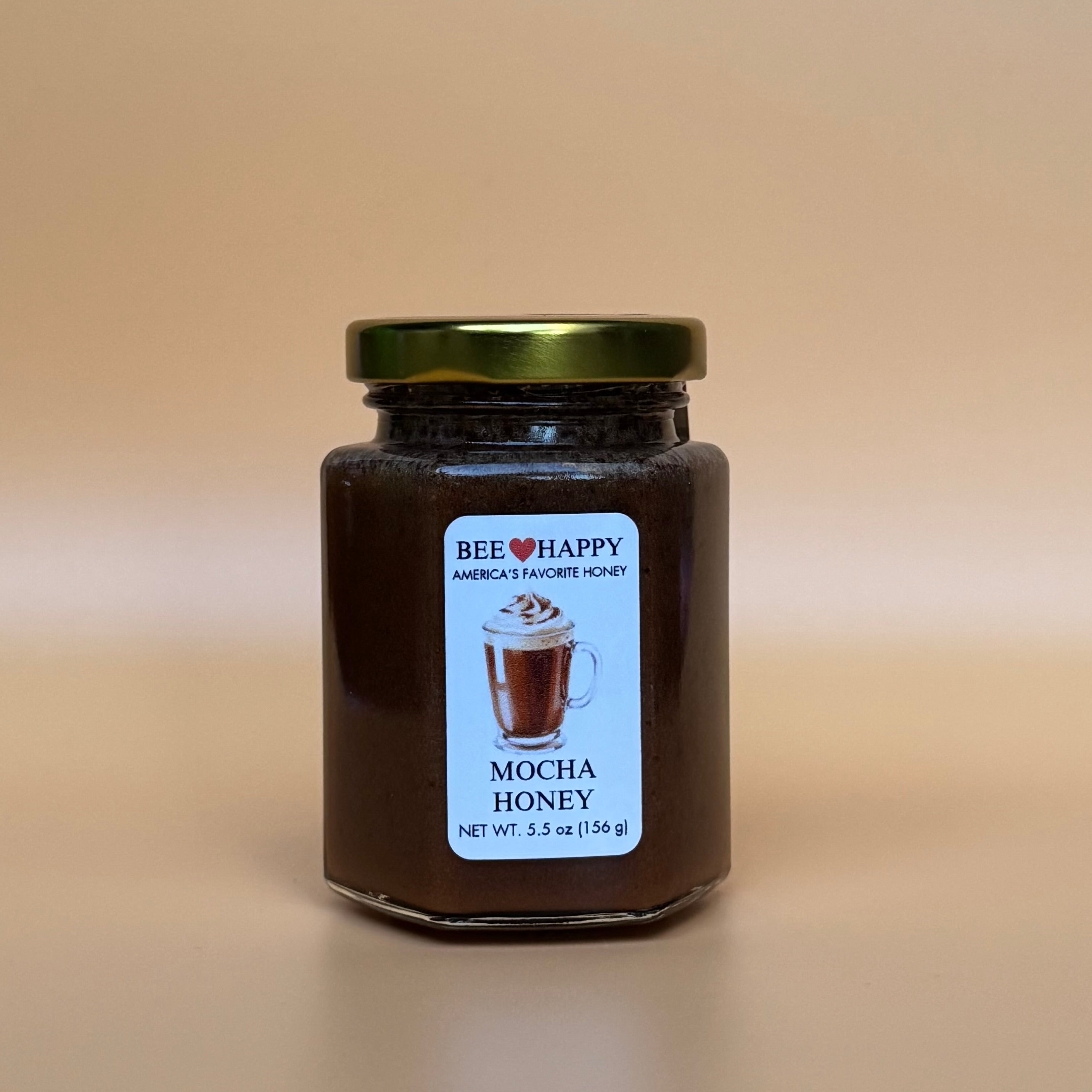 5.5 oz jar of Bee Happy Mocha Honey with a beige background.