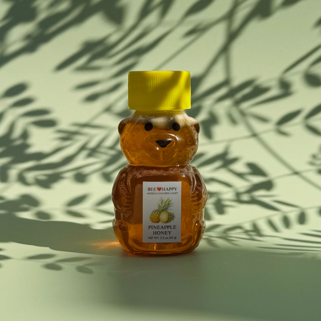 2.3 oz bear bottle of Pineapple Honey against a light background