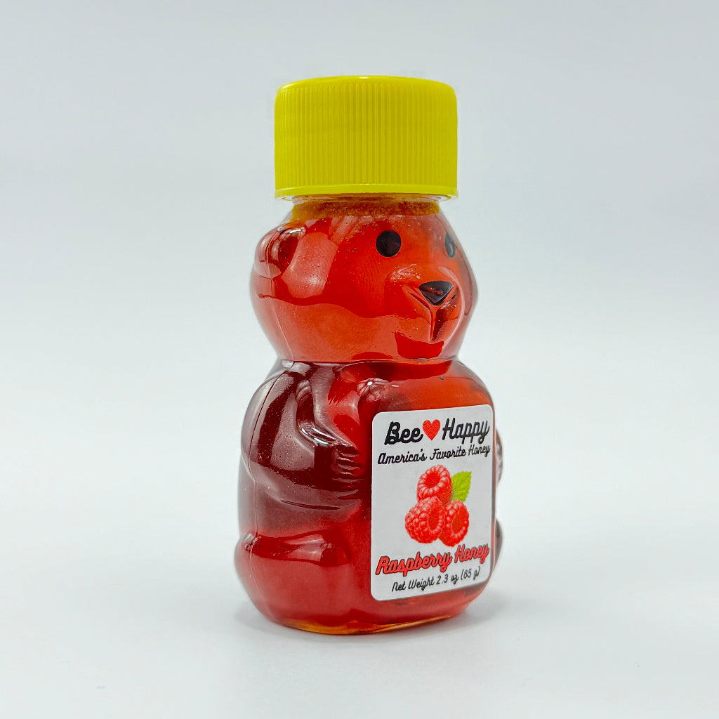 2.3 oz bear bottle of Raspberry Honey against a white background, facing diagonally to the right