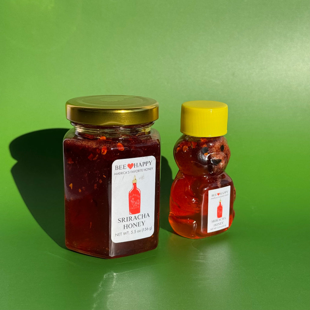 Angled view of 2.3 oz bear bottle and 5.5 oz jar of Sriracha Honey with a green background