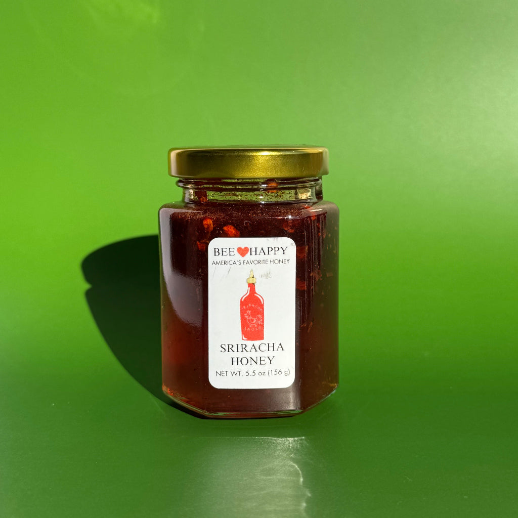 5.5 oz jar of Sriracha Honey with a green background