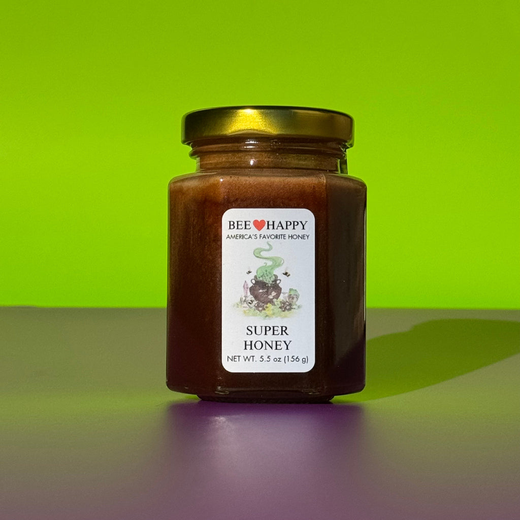 5.5 oz jar of Bee Happy Super Honey on a green and purple background