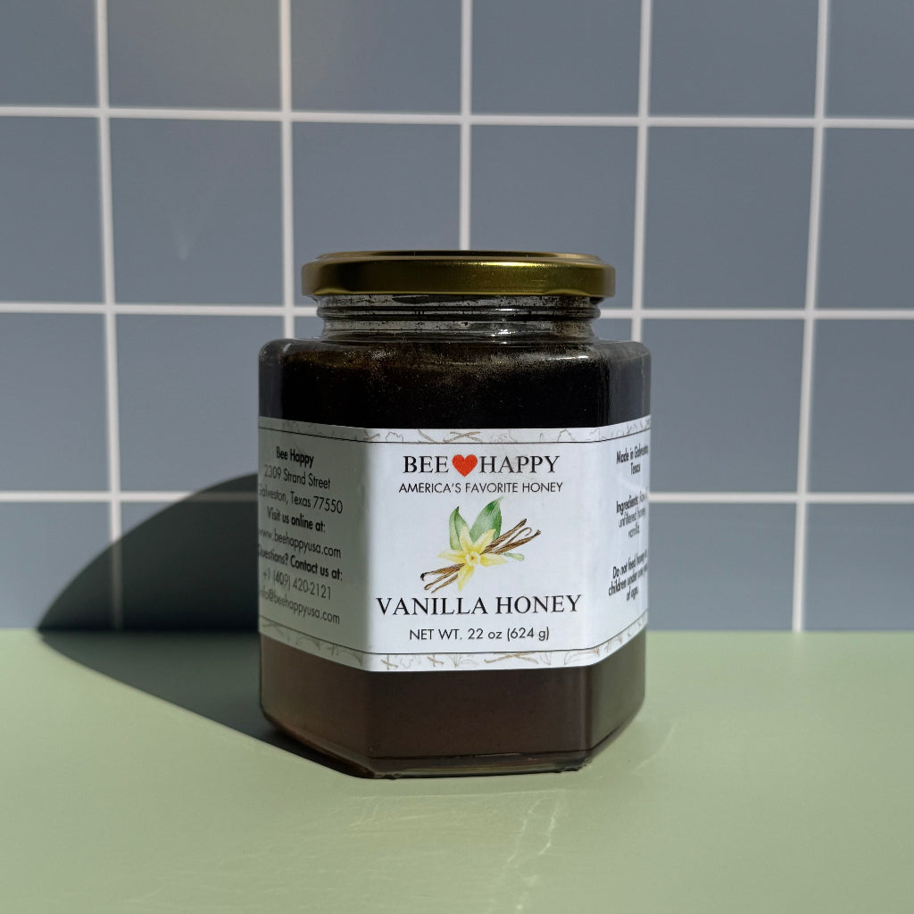 22 oz jar of Bee Happy Vanilla Honey on a gray checkered background