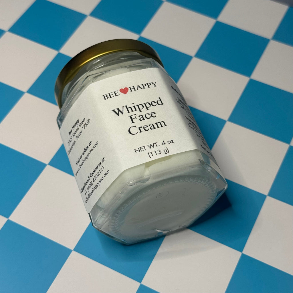 Jar of Bee Happy 4 oz Whipped Face Cream on a blue and white checkered background