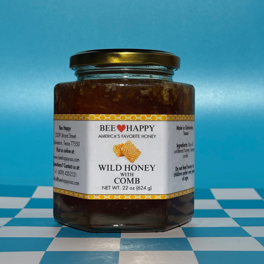 22 oz jar of Bee Happy Wild Honey with Comb on a blue and white checkered background